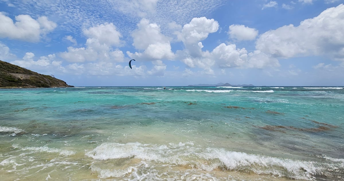 View on mini Waves at Mayreau Island with few people kitesurfing