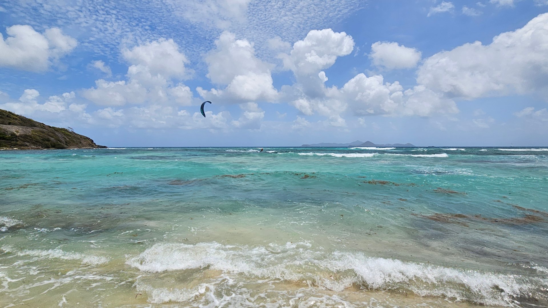 View on mini Waves at Mayreau Island with few people kitesurfing