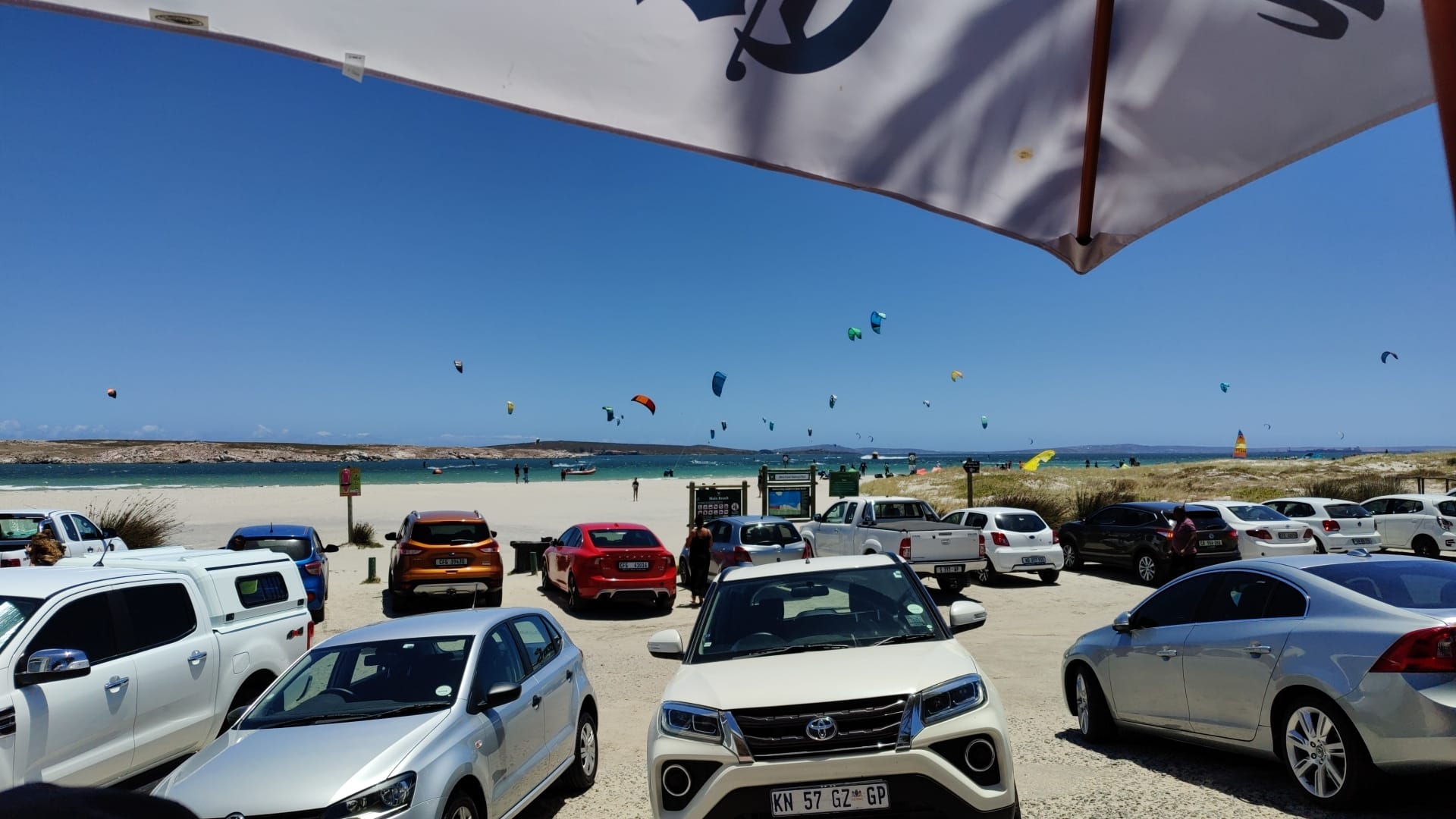 Parking Lot at Langebaan with crowded kitesurfing beach in the background