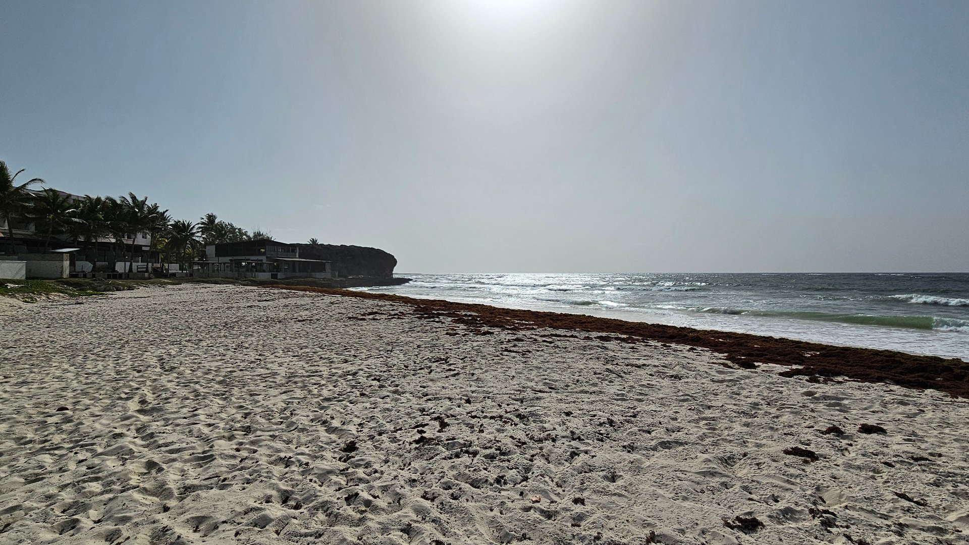 White beach with seagrass at Silver Sands and Rock with view to the Rock