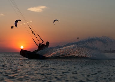 Aliki Beach Kitesurfing in Limnos with a few kiters in sunset on the water