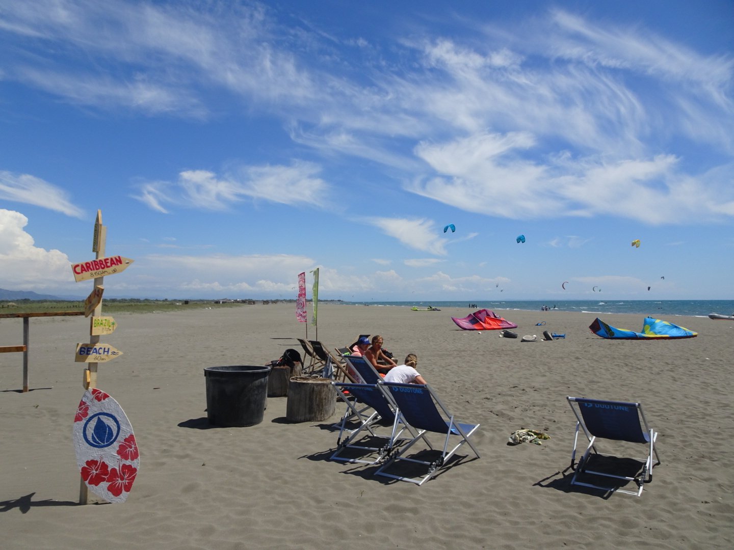 People relaxing in chairs after heavy kite session in Montengro