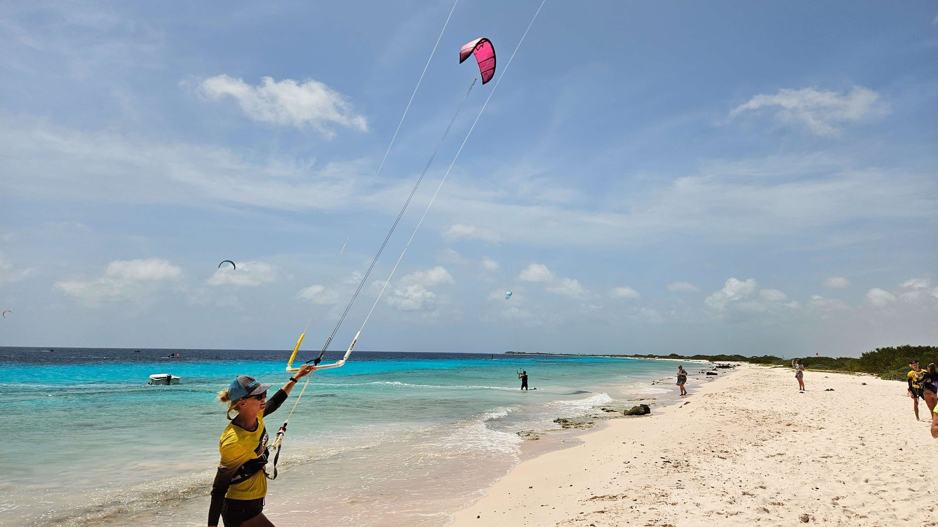 Atalntis Beach Kitesurfing Bonaire kitesurfing woman coming out of the water smiling