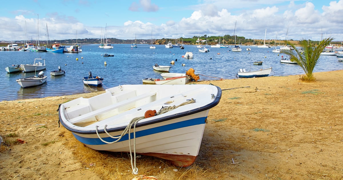 beatufiful view of the beach against scenic sunset in alvor