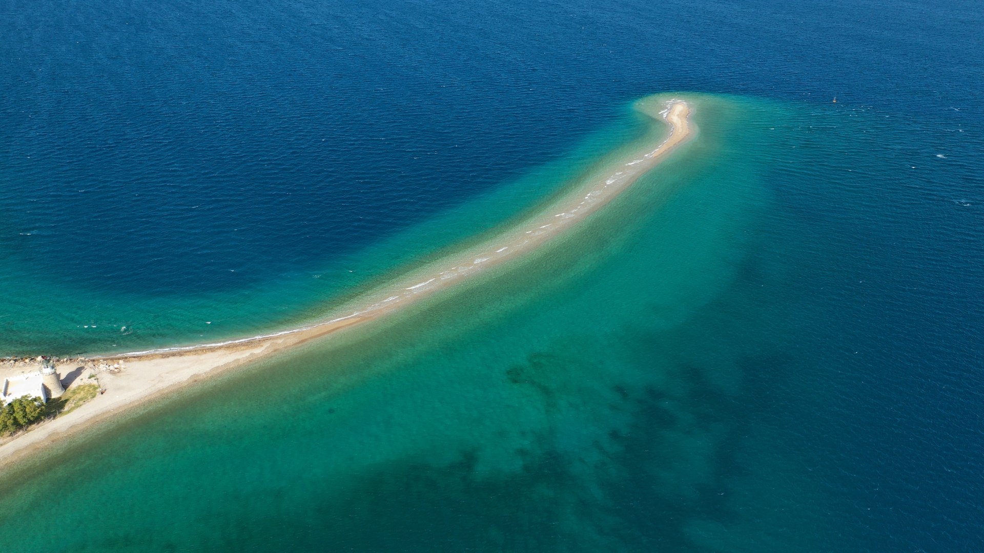 Cape Drepano Kitesurfing in Greece aerial picture ot the long beach like a finger pointing to the ocean