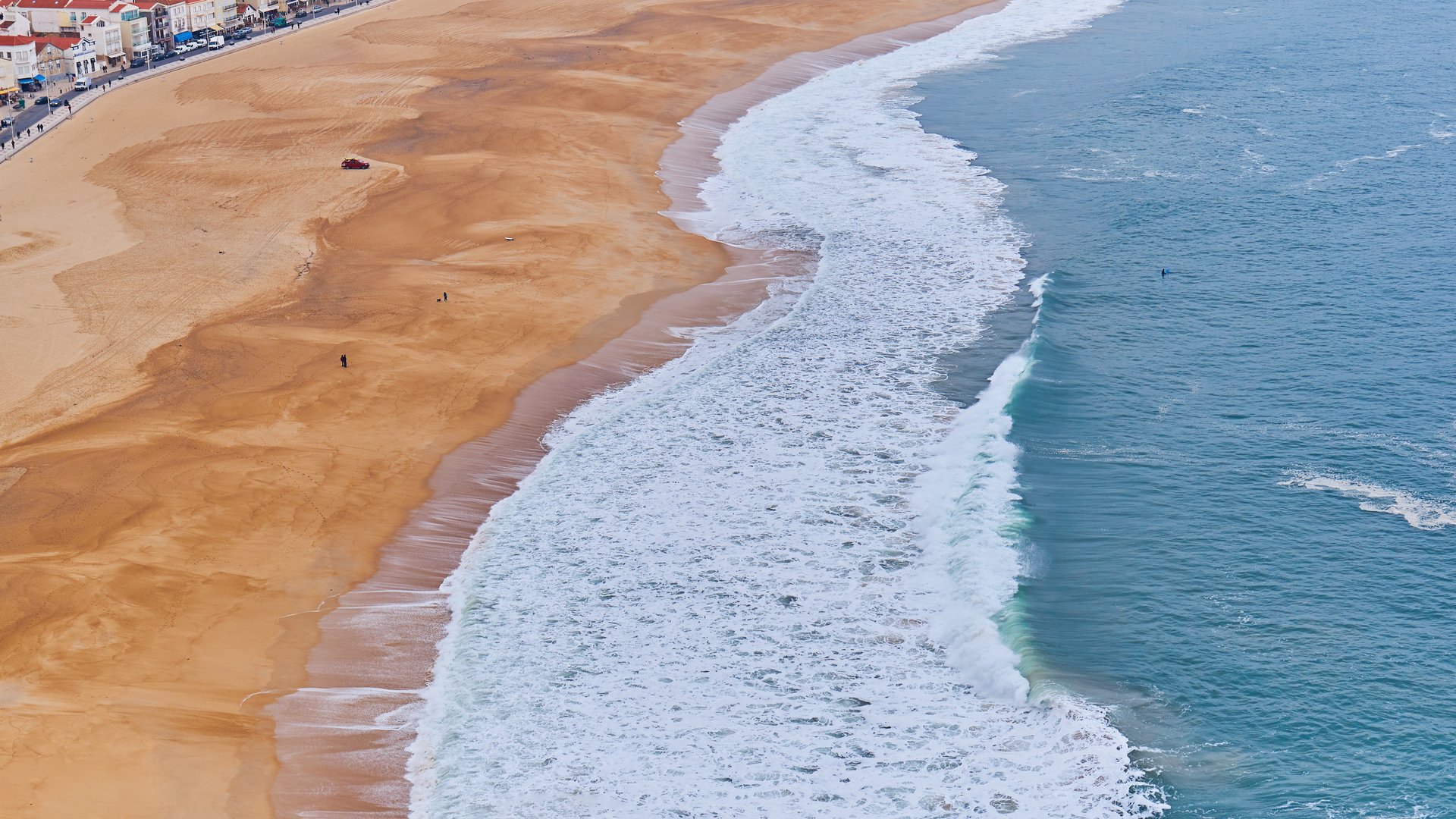 Aerial view of sandy beach and ocean coastline in Nazare