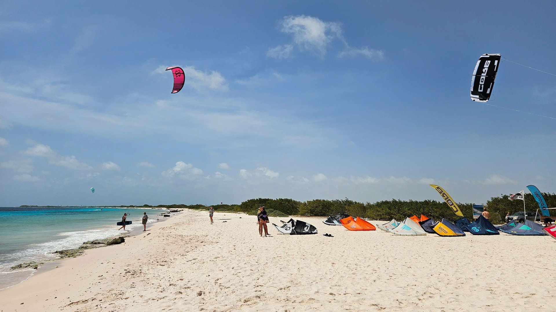 Atalntis Beach Kitesurfing Bonaire kiters on the beach with blue sky