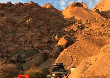 Tent and Jeep in magical sunset lighting in the Desert of Namibia