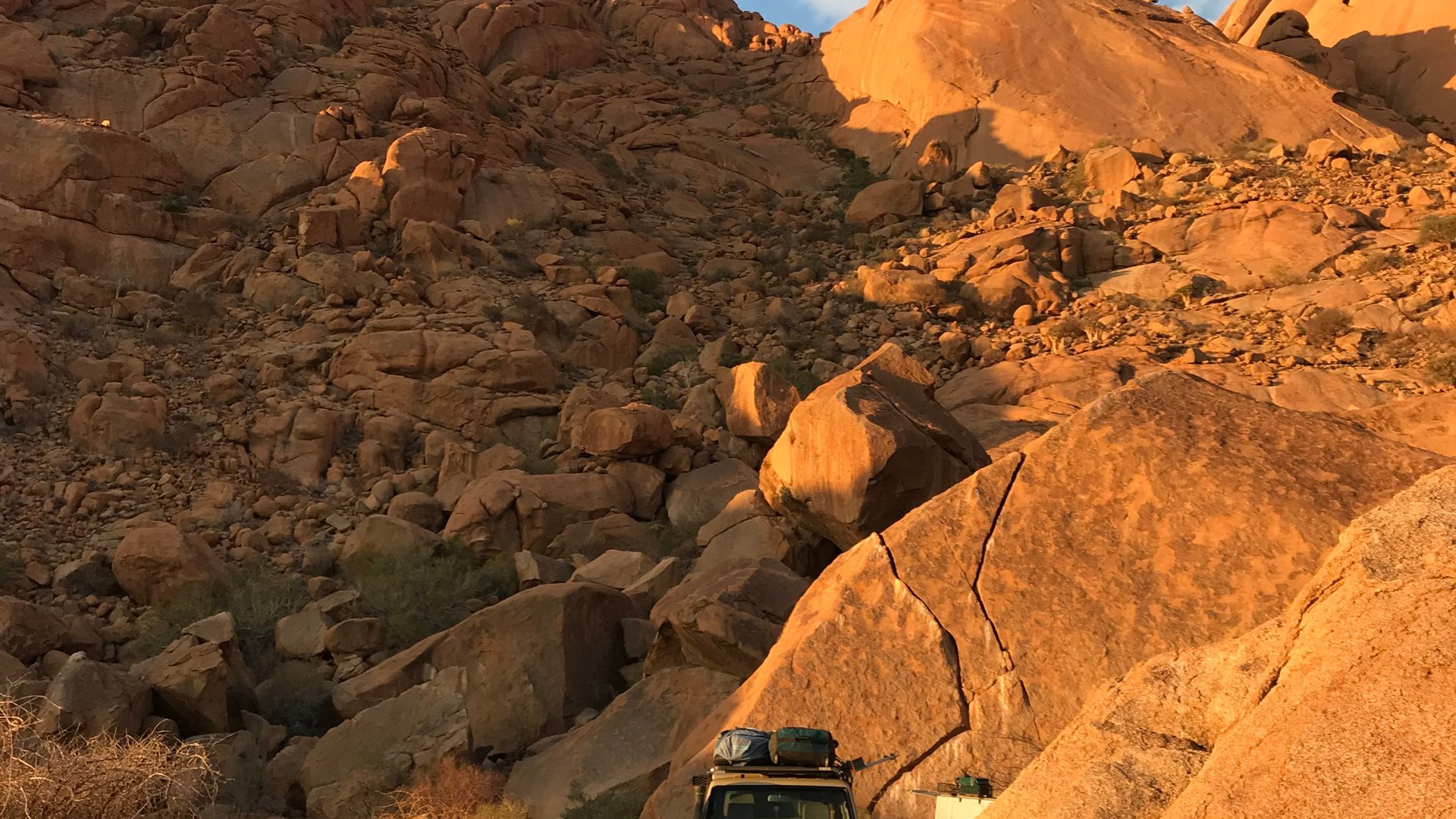 Tent and Jeep in magical sunset lighting in the Desert of Namibia