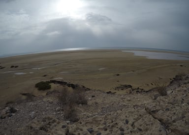 Sotavento Lagoon Kitesurfing in Fuerteventura water visible from far surrounded by brown stony and sandy landscape