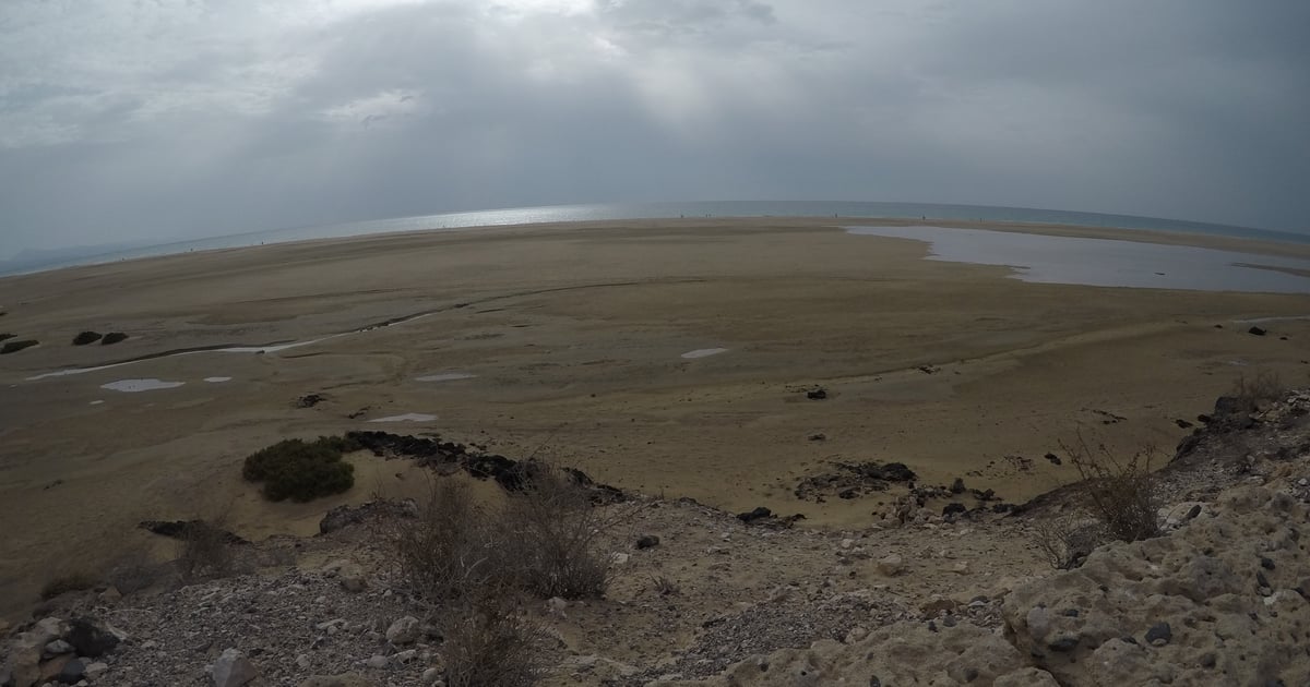 Sotavento Lagoon Kitesurfing in Fuerteventura water visible from far surrounded by brown stony and sandy landscape