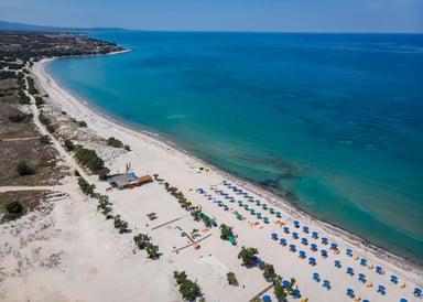 Marmari Beach Kitesurfing in Kos view from above along the large sandy beach with lounge chairs and the turqouise ocean