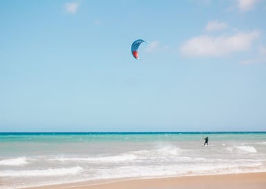 Kitesurfer at Matas Blancas Beach with small waves and typical white sand