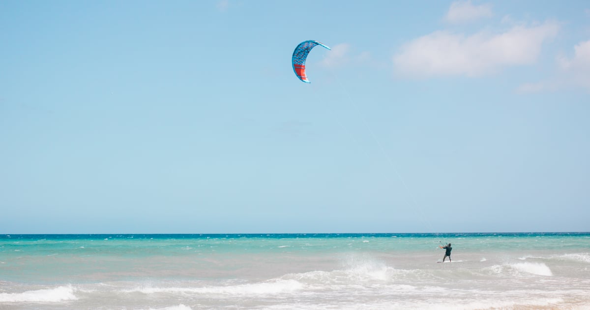 Kitesurfer at Matas Blancas Beach with small waves and typical white sand