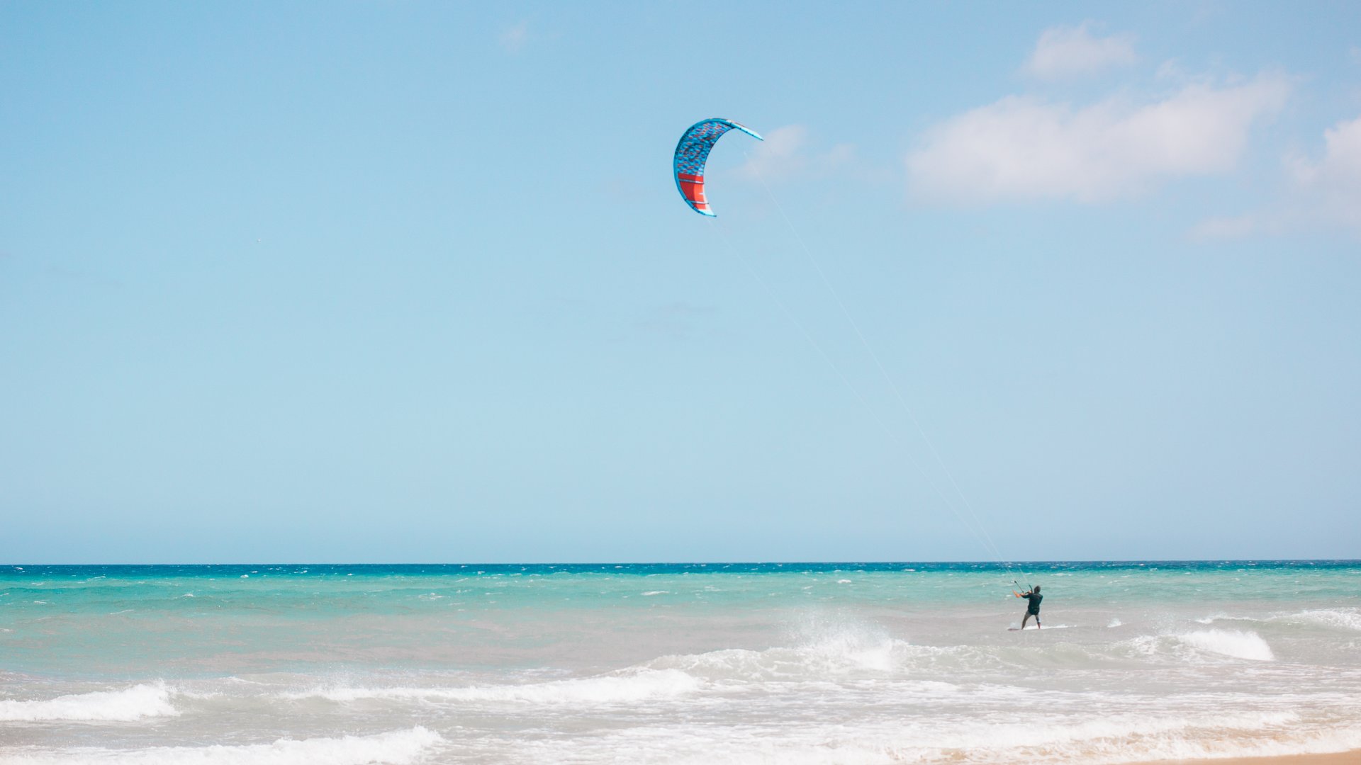 Kitesurfer at Matas Blancas Beach with small waves and typical white sand