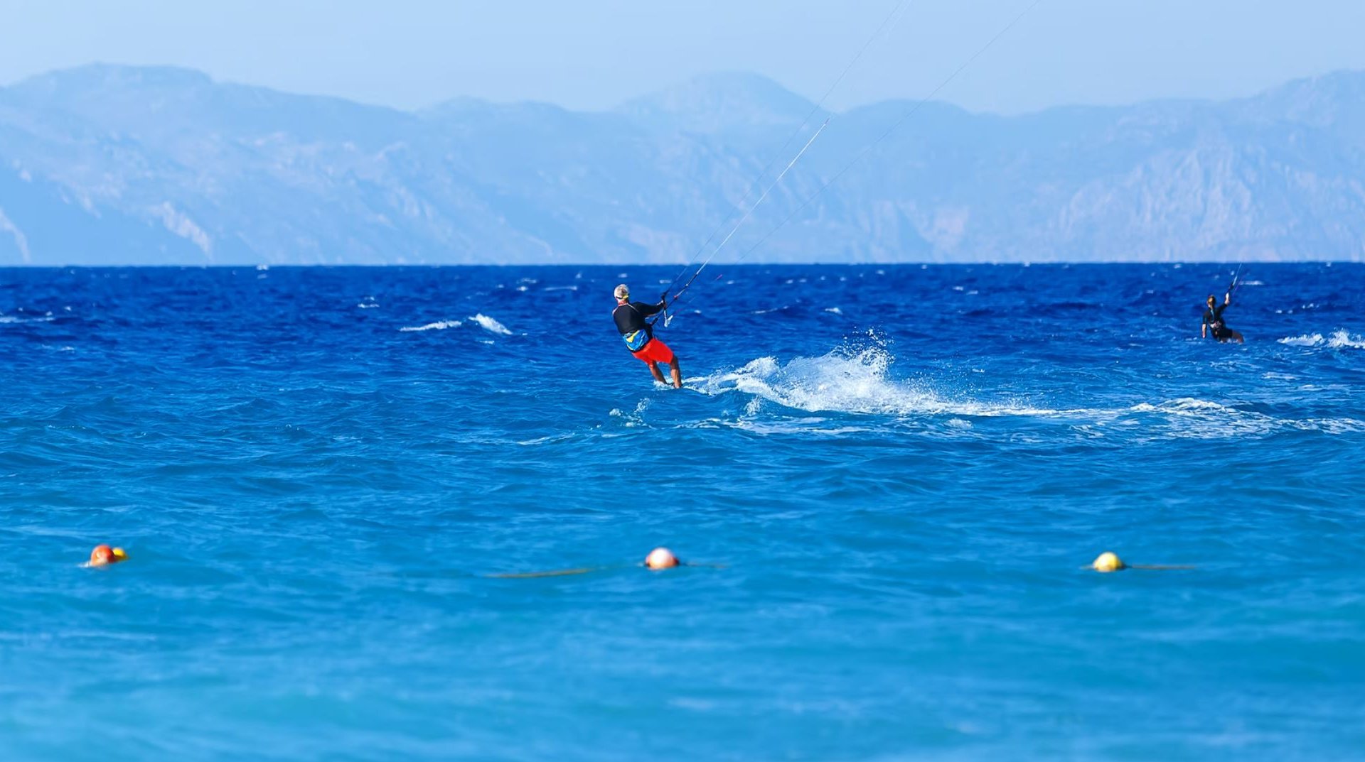 Lefkada Beach Kiteboarding in Lefkada shot of a older man on a kiteboard on the water