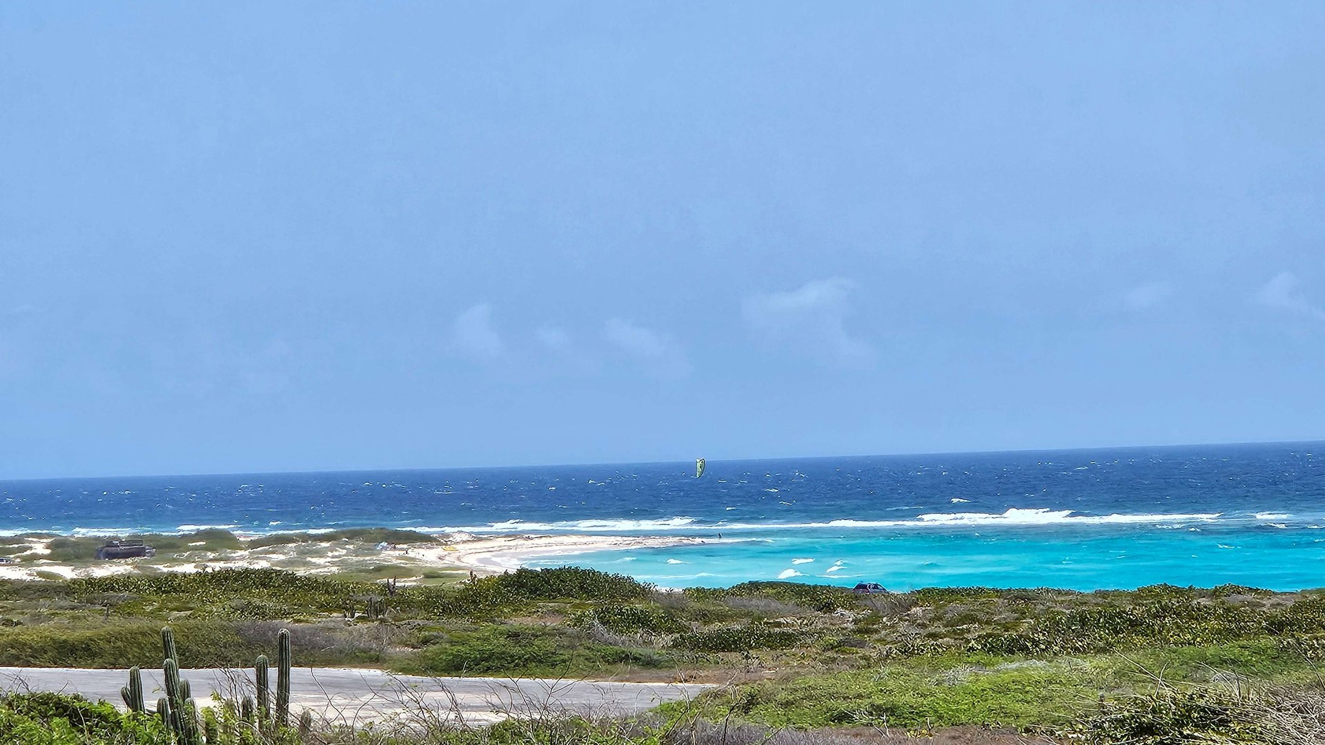 Boca Grandi Kitesurf Spot Bonaire view from the street to the bay with blue sky