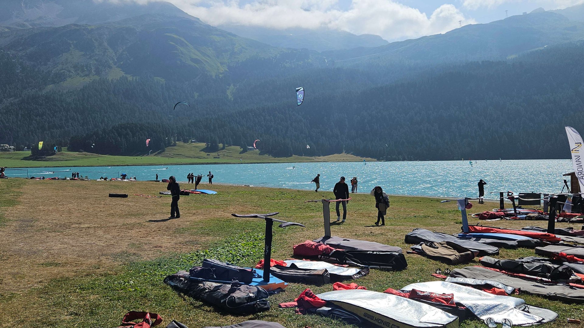 View on green grass landing zone at lake Silavplane with Foildboards in front 