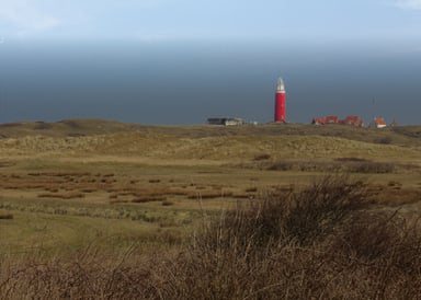 Texel Kitesurfing Island with lighthouse on the horizon of the sea