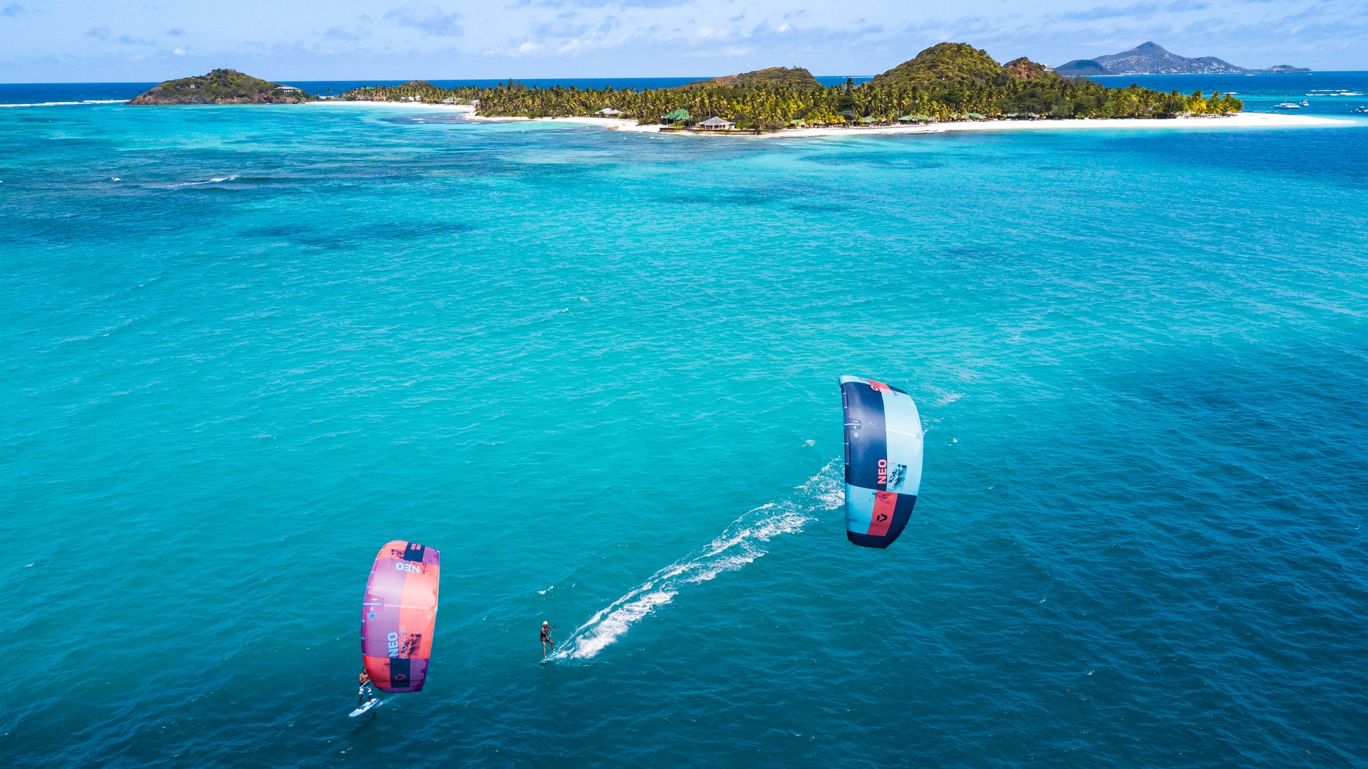 2 kitesurfers having a kite session in front of Palm Island in Saint Vincent and the Grenadines