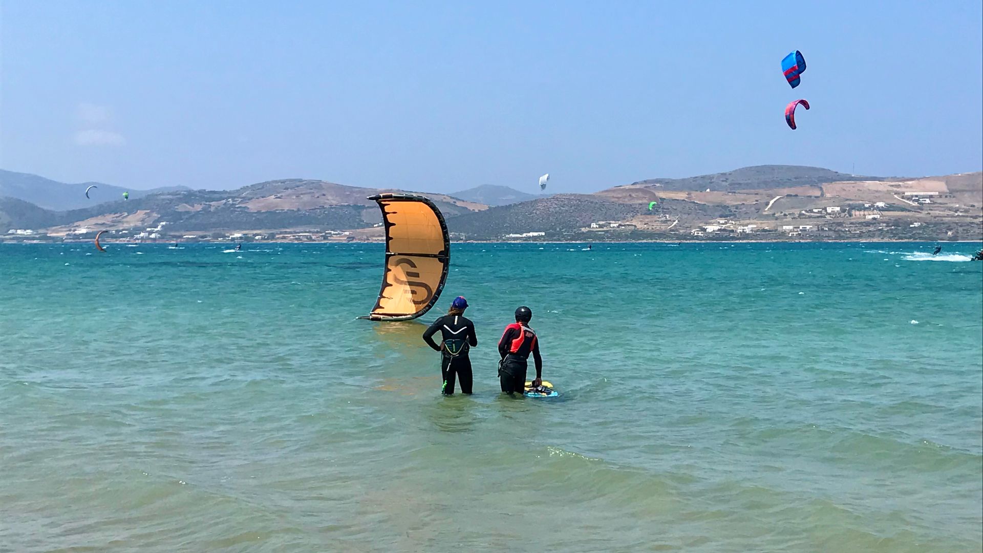 Paralia Pounta Kiteboarding in Kos a kite instructor and student in the water giving instructions
