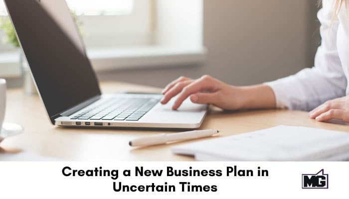 Creating a new business plan with a laptop and notebook.