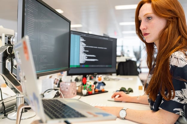 A woman in an office researching the request for proposal process on her computer