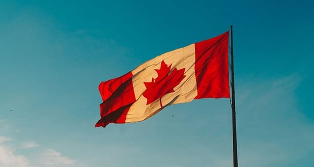 The Benefits and Challenges of Expanding Your Business into the Canadian Market - flag flying