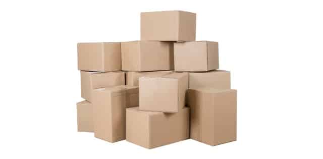 A small pile of variously sized, stacked cardboard boxes sits on a white surface. The background is plain white.