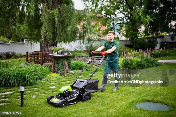 Lawn care worker mowing a residential yard
