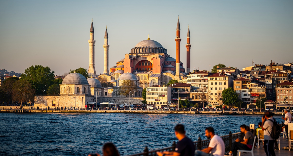 Hagia Sophia and Blue Mosque across the Bosphorus strait in Istanbul at golden hour with minarets silhouetted against a warm sky, representing Turkey and the +90 international dialing code