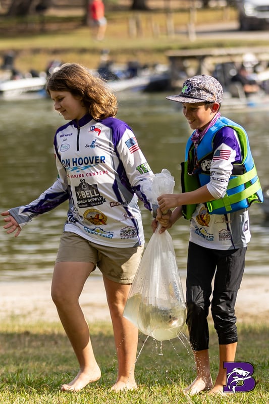Boerne Bass Club 2026 tournament weigh-in with Couture Floors and Williamson Roofing sponsor banners