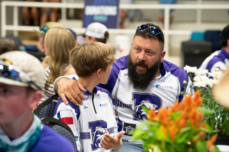 Two participants at a Boerne Bass Club tournament share a conversation.