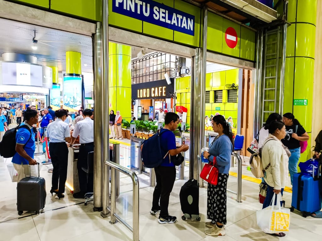 Penumpang KAJJ di Stasiun Gambir melakukan boarding menggunakan face recognition di pintu selatan