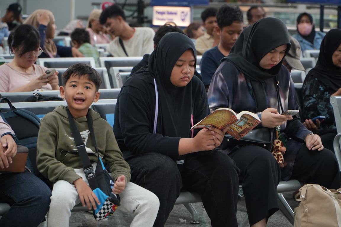 Ekspresi Ceria Seorang Anak saat Menunggu Kedatangan Kereta di Ruang Tunggu Stasiun Jatinegara. (29/6)