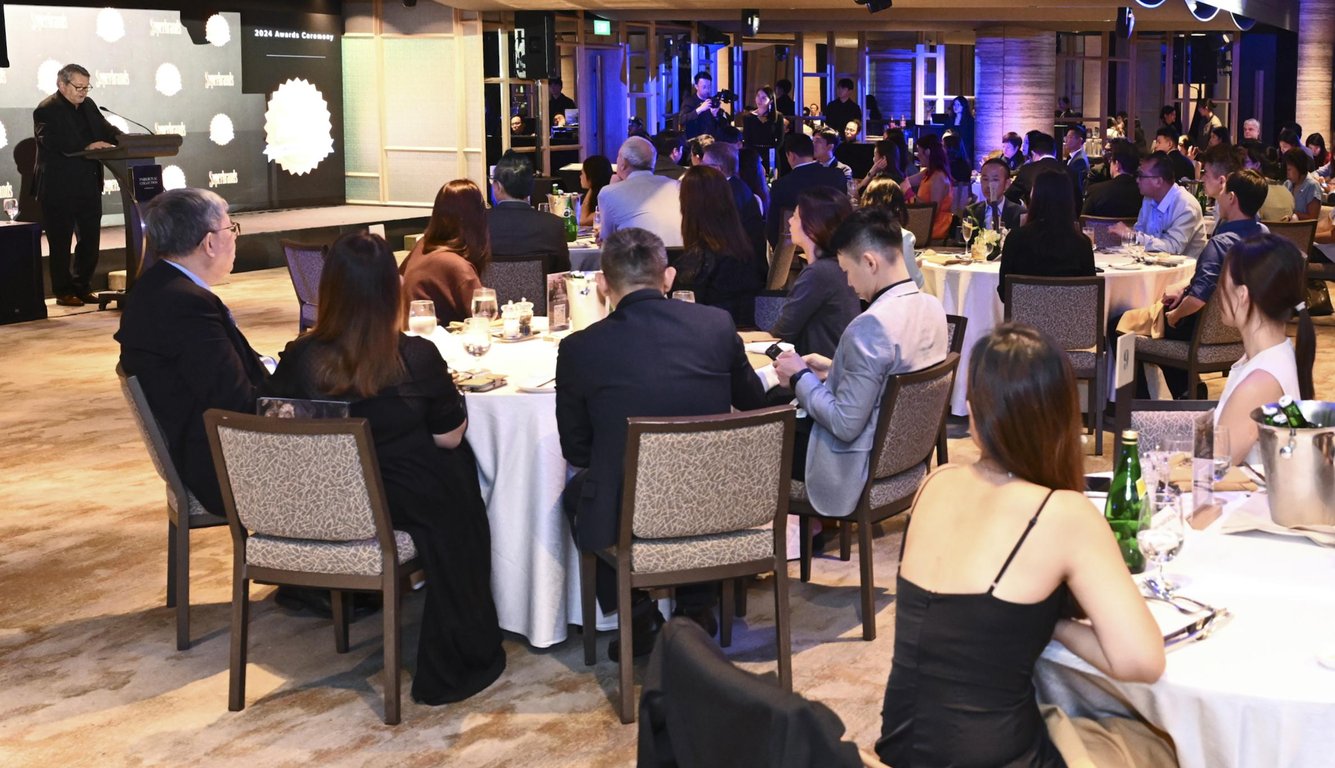 Superbrands Singapore CEO, Mark Pointer, congratulating awardees at the Superbrands Awards Ceremony 2024