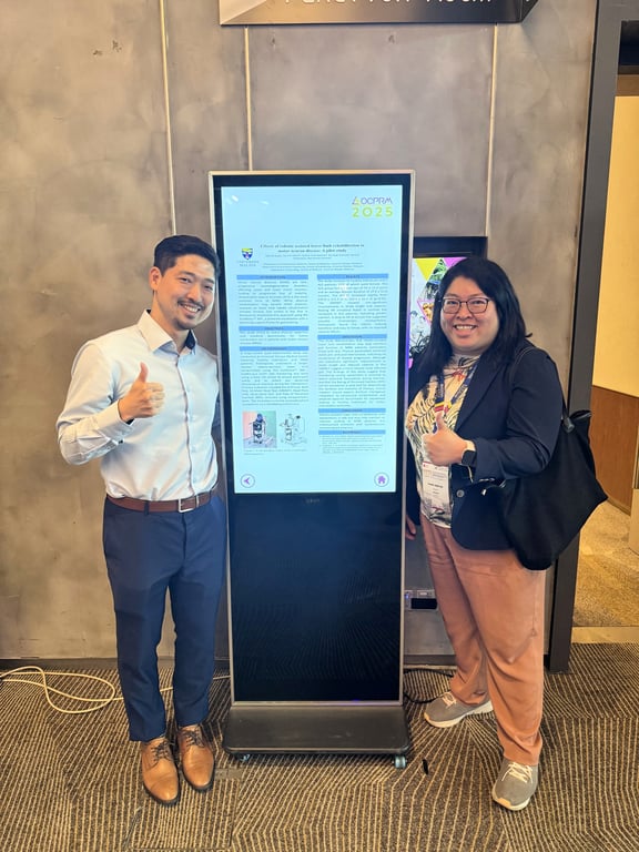 Picture 5: Owen TEOH, Managing Director of Fourier Rehab International Division, alongside a poster by UMMC (Universiti Malaya Medical Centre), regarding the ExoMotus™ M4. 