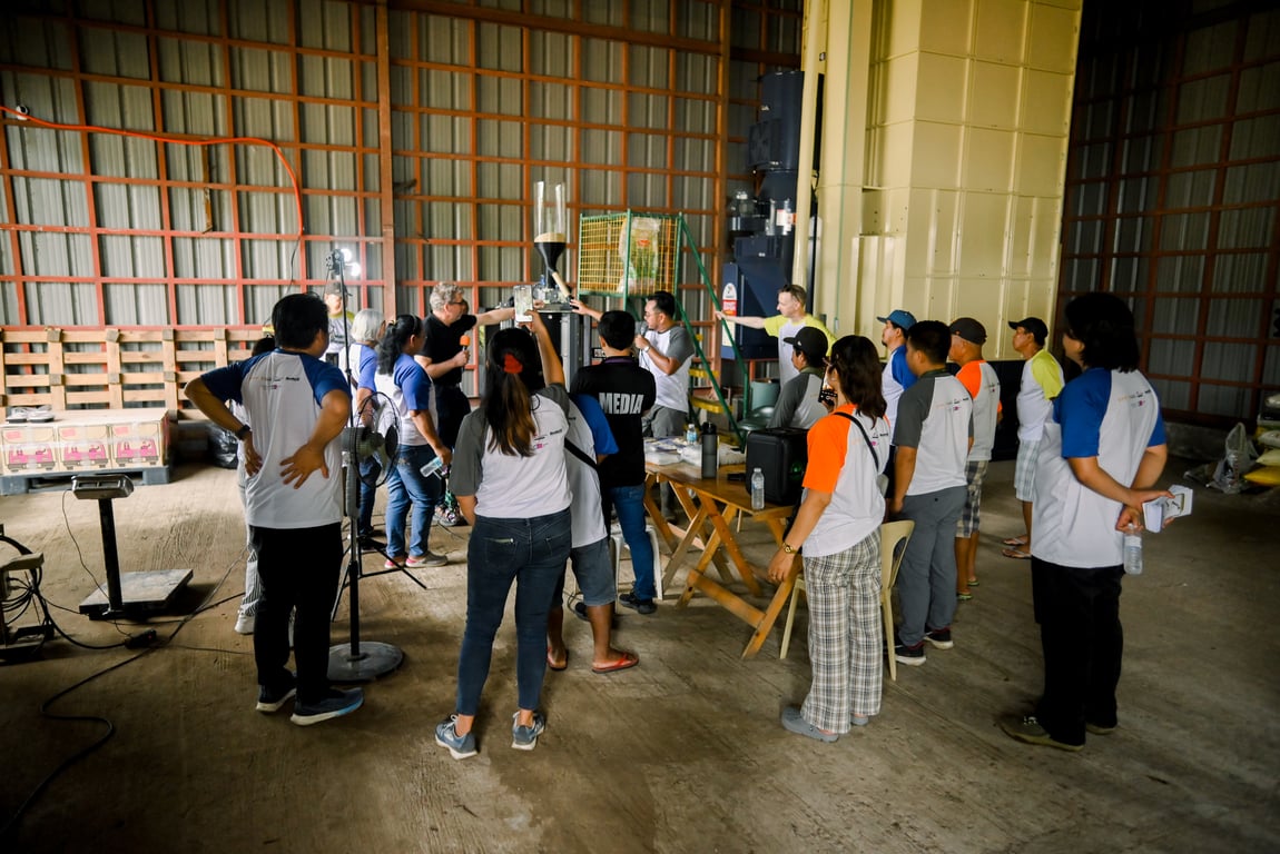 Farmers and guests observe the KoolMill efficient milling technology in action, which uses less energy while improving rice milling efficiency and quality.