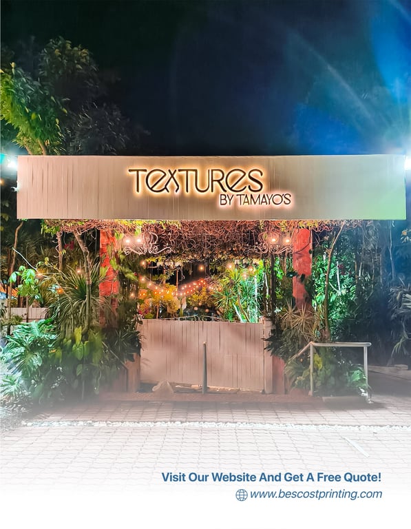 A beautifully lit signage installation for “Textures by Tamayo’s,” surrounded by lush greenery and ambient lighting—expertly crafted and installed by Bescost to elevate the venue’s identity and atmosphere.