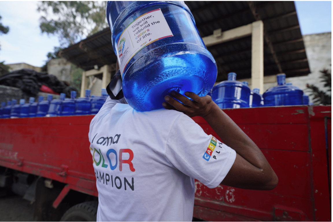 A volunteer loads a water container on a truck. This will be delivered to the quake-hit communities in Sarangani and General Santos City.