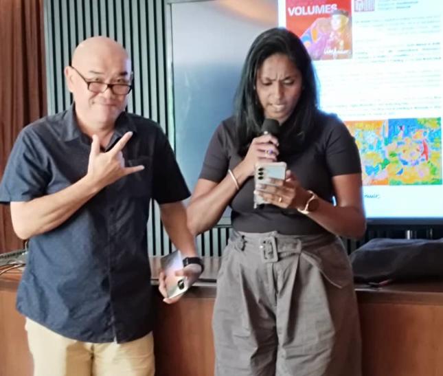 Hearing-impaired Malaysian artist Annuar Lim with his contemporary Batek artwork