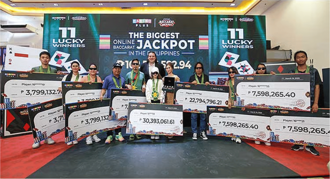 Casino Plus CEO Evan Spytma (center) with the 11 winners of the ₱102,576,582.94 Baccarat jackpot, turned over on&nbsp;March 19, 2025. At the time, it was the largest online baccarat payout on record in the Philippines.