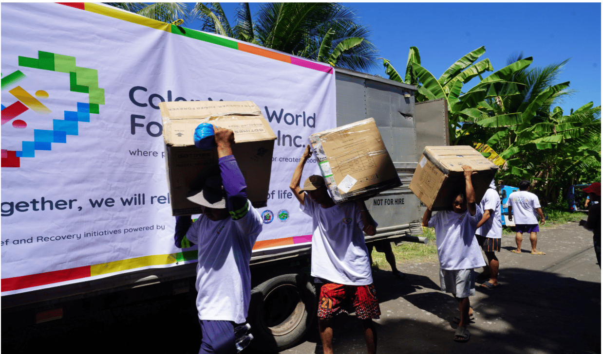 Volunteers from Color Your World Foundation help bring 'makulay' boxes containing the health kits on June 25. 
