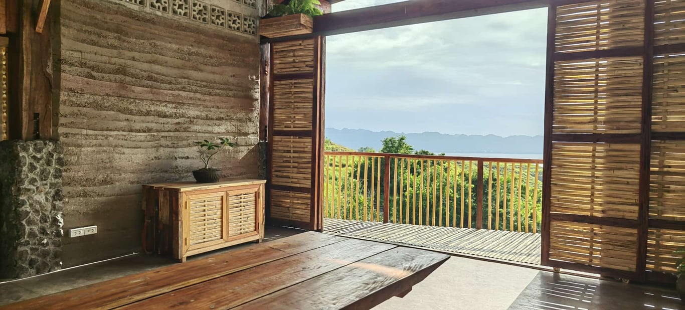 A view of the farm and mountains through its traditional wooden doors.