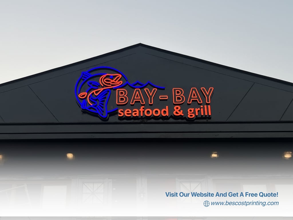 A sleek neon sign for Bay-Bay Seafood & Grill stands out against the dusk sky—designed to be bold, visible, and memorable, even as daylight fades.