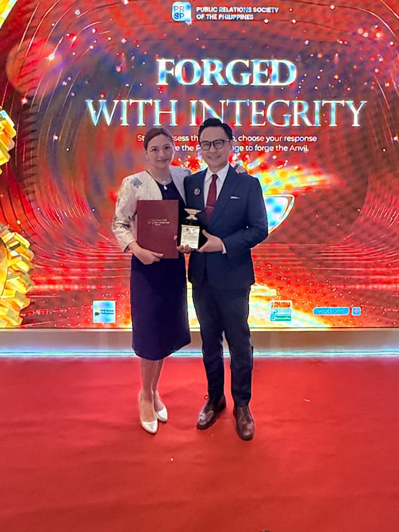 Forged with Integrity: Immediate Past President Karlo Benjamin Nisce and Dr. Diana Nisce celebrate RCNME's historic first, an Anvil Award for a Rotary coffee table book.