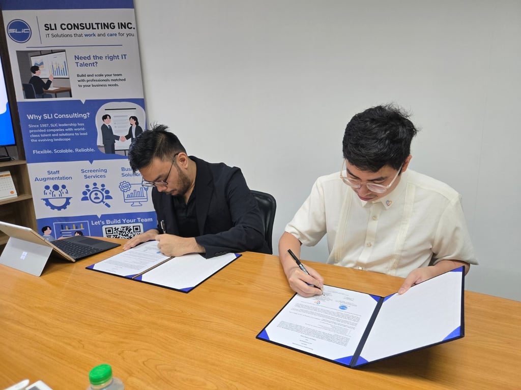 Gabriel Pablo Cervantes, President of SLI Consulting Inc., and Gabriel Avelino Sampedro, Ph.D., SMIEEE, CEO of Philippine Coding Camp, formalize the partnership between the two organizations.