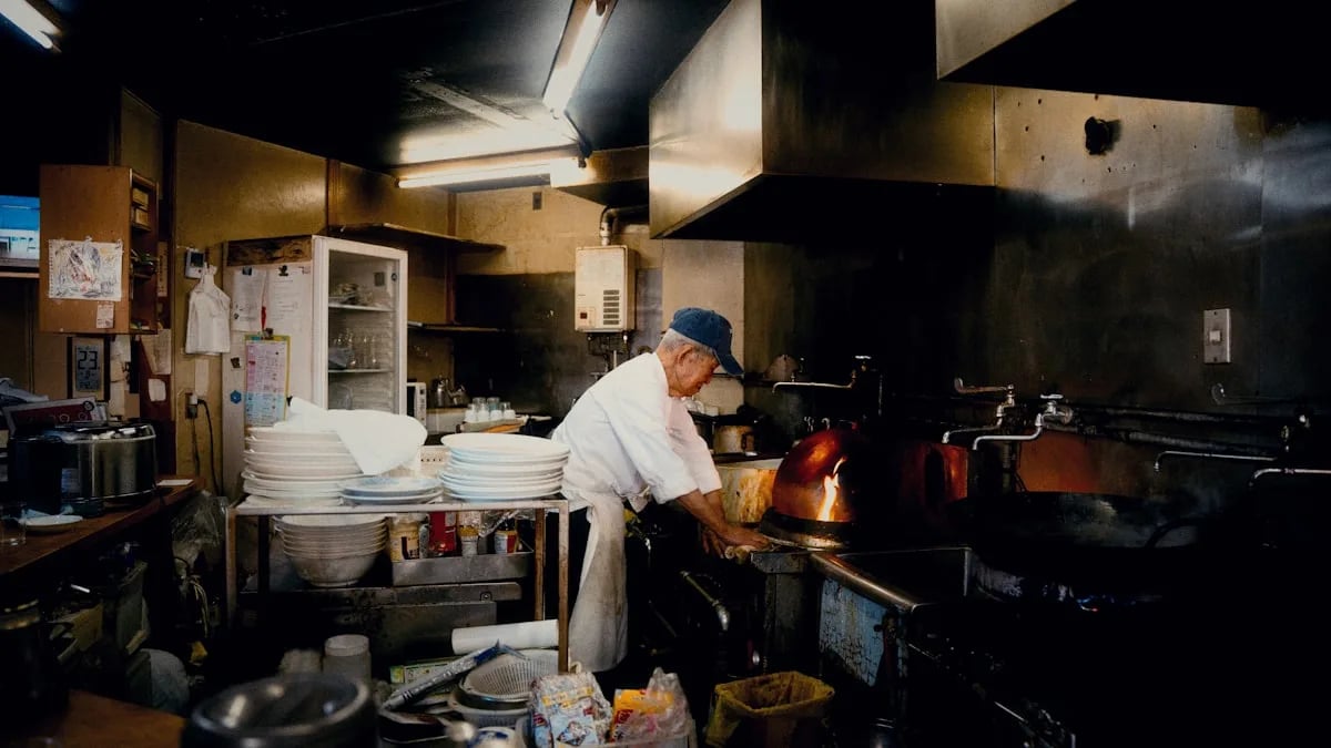 A lone chef in whites standing calmly at a pass during a busy service, soft dramatic lighting, steam rising, blurred.
