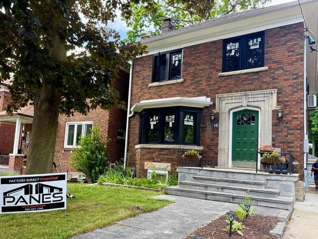 Black-framed Panes replacement windows on the upper and ground floors of a Toronto red-brick home