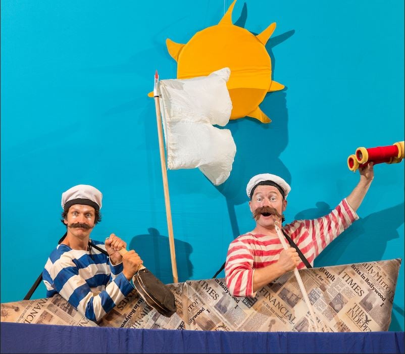 תמונה של 2 שחקנים ישובים בסירה מנייר